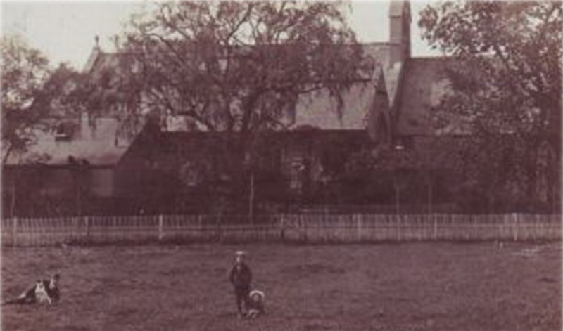 Photograph of Christ Church from the south in what once were fields; the Parish Room or 'Tin Tab' is visible on the left