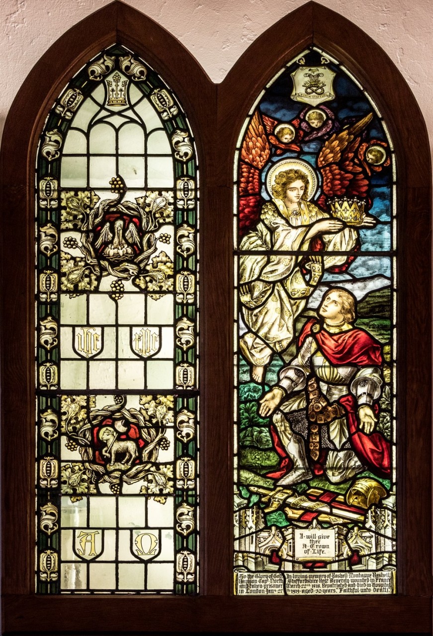 Photo of the stained glass windows in memory of Frederick Merryweather (on the left) and Rashell Montague (Monty) Davison (on the right) with the verse from Revelation 2.10 'I will give you the crown of life'