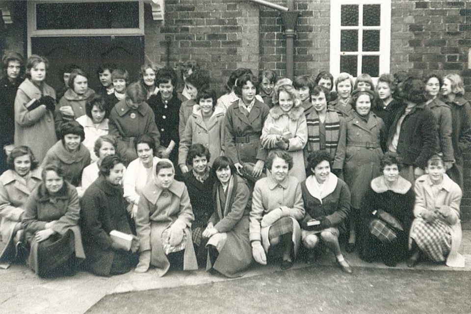 Group photo of Pathfinder girls taken outside the Parish Halls in 1962