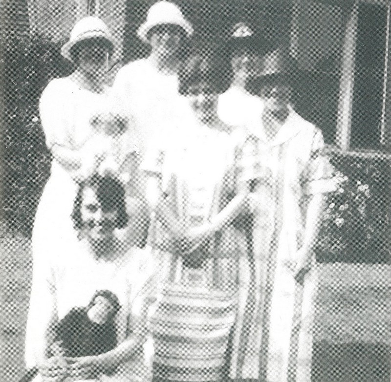 Photo of Nancy Symes and friends as a Church fete in 1926, one holding a toy monkey