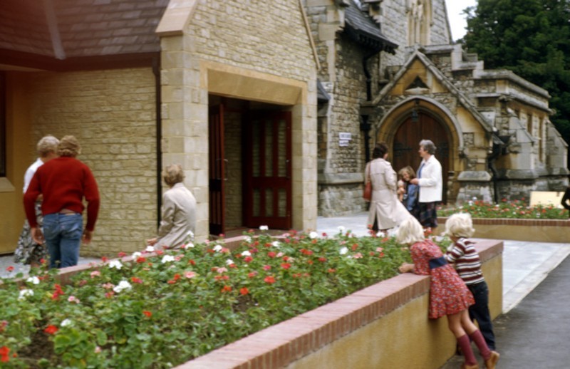 Photo showing the entrance to the church via the Christ Church centre with flower beds in the foreground