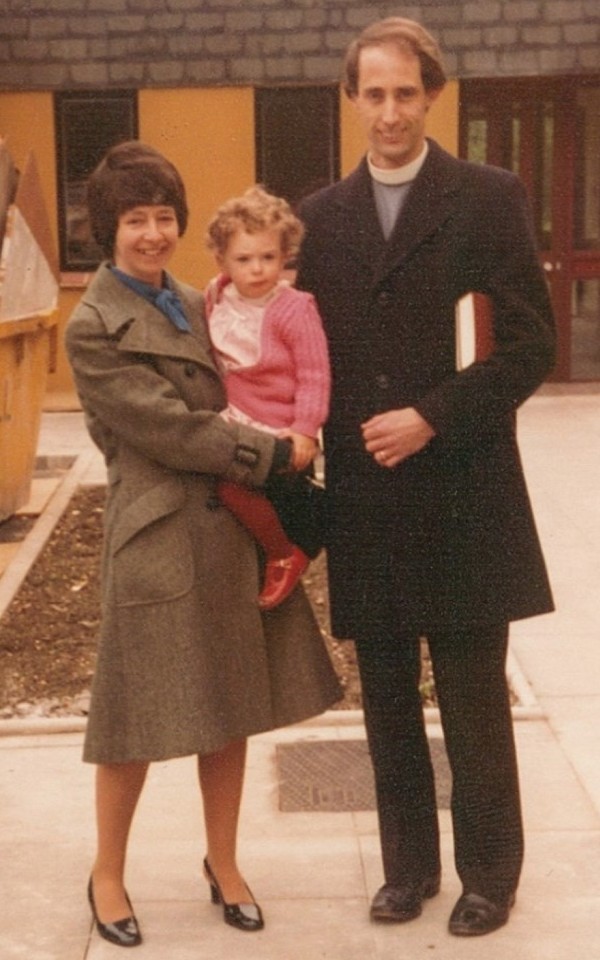 Photo of Geoff and Jenny Maughan with one of their two daughters; Geoff has a Bible tucked under his arm