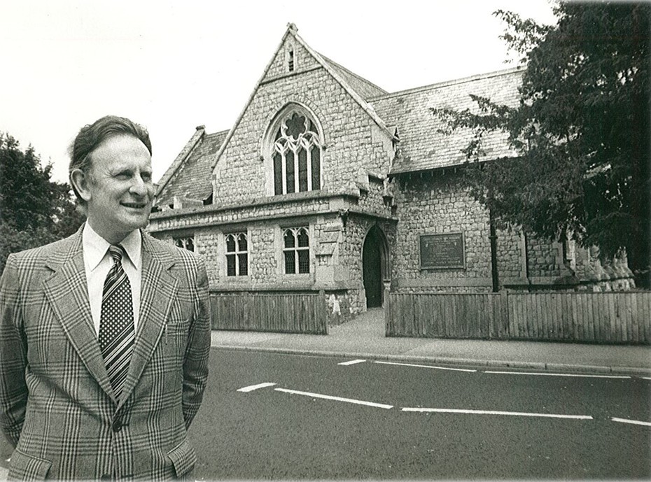 Photo of John Short standing across the road with Christ Church in the background