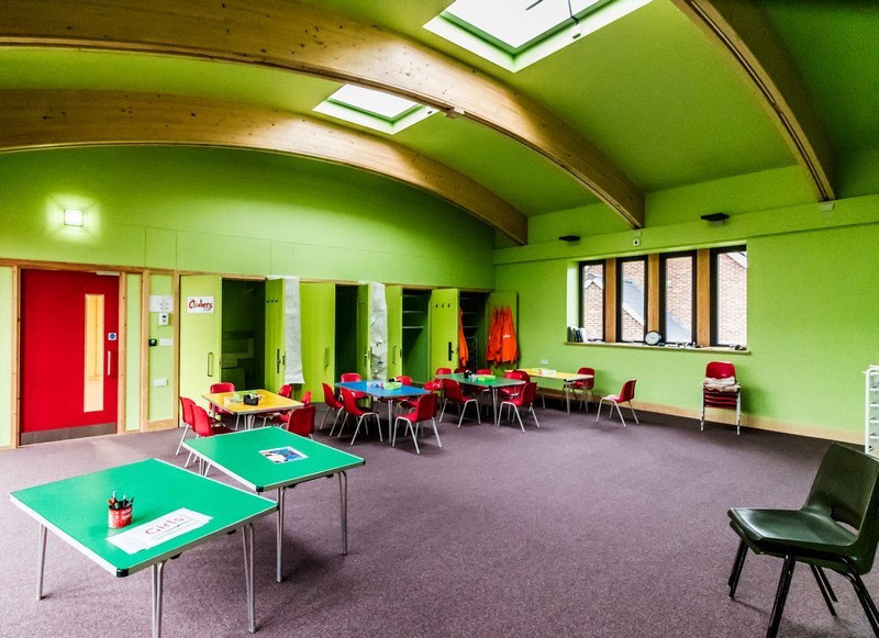 Photo showing the new Climber's room with tables in place, lime green painted walls and 'Climbers' painted on the far wall
