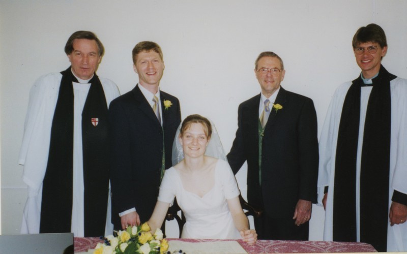 Photo from the wedding of Jo and Iain Gutteridge; Jo is signing the register, with Stewart Downey and Steve Benoy present