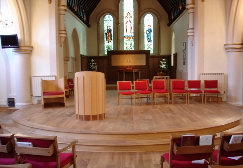 Photo following the re-ordering showing the new church platform, with new pulpit in place and chairs for the music group