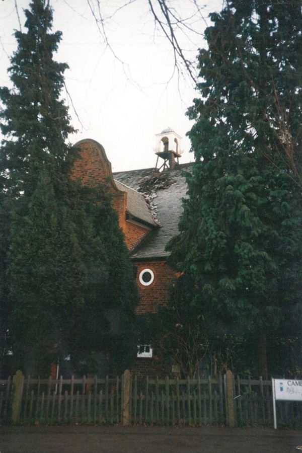Photo showing the Parish Hall exterior after the 1996 fire, with visible damage to the roof
