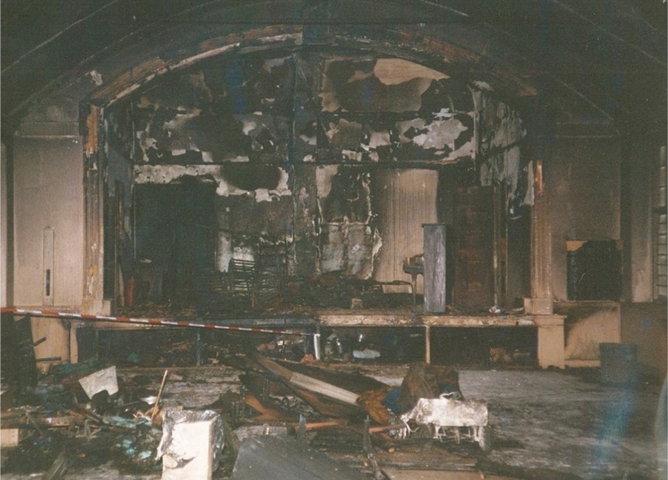 Photo of the Parish Hall interior (upper floor) after the 1996 fire, showing damage done