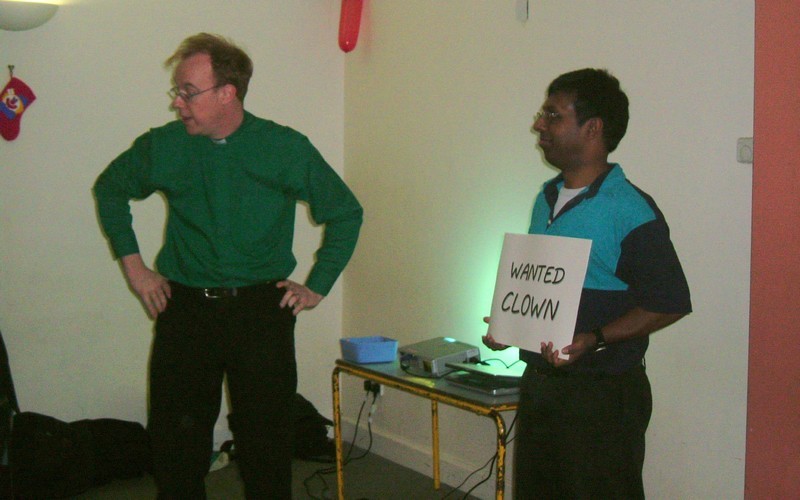 Then curate Stephen Kuhrt giving a talk, pictured with an assistant holding up a sign saying 'Wanted: Clown'