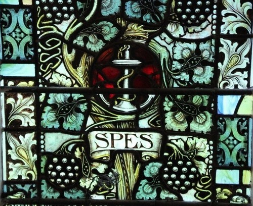 Close up of the depiction of 'Spes'; above the wording an anchor amidst a vine bearing bunches of grapes