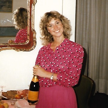 Photo of Susie Morris holding a bottle of bubbly