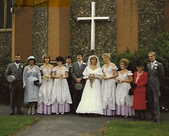 Wedding photo of Susie and John Morris with parents, Best Man and bridesmaids