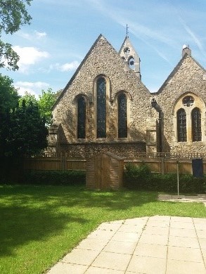 Photo of the east wall of the church from the new Vicarage; the tree has been removed and the window is now fully visible